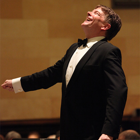 Conductor conducting and smiling